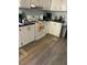 Well-lit kitchen with modern appliances, white cabinets, and dark countertops at 55 Waters Edge Loop, Henderson, NC 27537