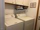 Functional laundry room features washer, dryer, storage cabinets, and laundry themed decor at 55 Waters Edge Loop, Henderson, NC 27537