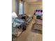 Living room featuring a gray sofa, tv, and wood floors at 55 Waters Edge Loop, Henderson, NC 27537