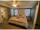 Main bedroom featuring a plush bed, and bright, sunlit windows; bathroom entrance visible at 55 Waters Edge Loop, Henderson, NC 27537