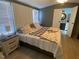 Main bedroom featuring a plush bed, and bright, sunlit windows; bathroom entrance visible at 55 Waters Edge Loop, Henderson, NC 27537