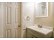 Well-lit bathroom featuring a stylish vanity with a gray cabinet and a decorative mirror at 5717 Woof Pl, Knightdale, NC 27545