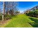 Expansive backyard with mature trees and lush green lawn, ideal for outdoor enjoyment at 604 Trunecek Cir, Raleigh, NC 27603