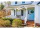 Inviting front porch with brick steps and a charming blue door at 604 Trunecek Cir, Raleigh, NC 27603