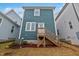 Exterior of backyard displaying a wooden stairway and a blue paneled wall at 662 Vine Pkwy, Pittsboro, NC 27312