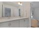 Bathroom features double sinks, chrome fixtures, and white cabinets, offering a clean and modern aesthetic at 662 Vine Pkwy, Pittsboro, NC 27312