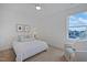 Bright bedroom features a ceiling fan, a large window, and neutral décor, creating a relaxing atmosphere at 662 Vine Pkwy, Pittsboro, NC 27312