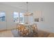 Bright dining room with a white table, light-wood chairs, modern lighting, and lots of natural light at 662 Vine Pkwy, Pittsboro, NC 27312