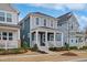 Inviting two-story home featuring a covered front porch and manicured front yard at 662 Vine Pkwy, Pittsboro, NC 27312