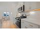 Modern kitchen features stainless steel appliances, white cabinets, and views to dining room at 662 Vine Pkwy, Pittsboro, NC 27312