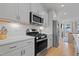Stylish kitchen featuring white countertops, modern appliances, and ample cabinet space at 662 Vine Pkwy, Pittsboro, NC 27312