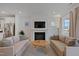 Comfortable living room boasts a fireplace, with stylish furnishings and natural light at 662 Vine Pkwy, Pittsboro, NC 27312
