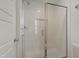 Clean, tiled walk-in shower with modern fixtures, a glass door, and a built-in shelf for toiletries at 662 Vine Pkwy, Pittsboro, NC 27312