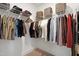 Walk-in closet features ample hanging space, wire shelves, and storage bins for optimal organization at 662 Vine Pkwy, Pittsboro, NC 27312