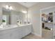 Well-lit bathroom featuring a double vanity and a view into the walk-in closet, adding convenience at 69 Alex Farm Ct # 21, Zebulon, NC 27597