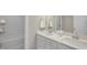 Bright bathroom featuring double sinks, a spacious tub, and neutral color palette at 69 Alex Farm Ct # 21, Zebulon, NC 27597