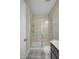 Well-lit bathroom with a modern glass-enclosed shower and stylish patterned tile floor at 69 Alex Farm Ct # 21, Zebulon, NC 27597
