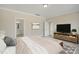 Relaxing bedroom featuring a king-sized bed, a TV, and access to an en-suite bathroom at 69 Alex Farm Ct # 21, Zebulon, NC 27597