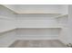Spacious walk-in closet featuring multiple shelves and wooden rods for optimal organization at 69 Alex Farm Ct # 21, Zebulon, NC 27597
