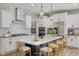 Bright kitchen with an island with chairs, stainless steel appliances, pendant lights, and white cabinets at 69 Alex Farm Ct # 21, Zebulon, NC 27597