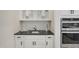 Convenient kitchenette area with white cabinets, black countertop, stainless steel sink, and modern appliances at 69 Alex Farm Ct # 21, Zebulon, NC 27597