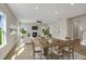 Open-concept living space with a fireplace, comfortable seating, dining area, and large windows overlooking backyard at 69 Alex Farm Ct # 21, Zebulon, NC 27597