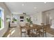 Bright living space with a fireplace, comfortable seating, dining area, and large windows overlooking backyard at 69 Alex Farm Ct # 21, Zebulon, NC 27597