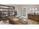 Well-lit office space with a wooden desk, a bookshelf, a comfortable chair, and a French door at 69 Alex Farm Ct # 21, Zebulon, NC 27597