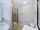 Bathroom featuring a glass shower with a tile surround, as well as a large mirror at 69 Azul Dr, Clayton, NC 27520