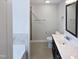 Bathroom featuring a tile shower with a glass door and a dark wood vanity at 69 Azul Dr, Clayton, NC 27520