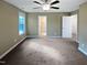 Spacious bedroom featuring a ceiling fan, plush carpet, and large windows at 69 Azul Dr, Clayton, NC 27520