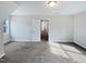 Bedroom featuring gray carpet, a window, and an adjacent closet and bonus space at 69 Azul Dr, Clayton, NC 27520