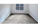 Bedroom featuring gray carpet, a double-hung window, and neutral paint at 69 Azul Dr, Clayton, NC 27520