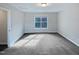 Bedroom featuring gray carpet, a window, and neutral paint at 69 Azul Dr, Clayton, NC 27520