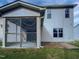 Two-story home featuring vinyl siding, a screened-in porch, and a brick paver patio at 69 Azul Dr, Clayton, NC 27520