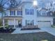 Charming two-story home with white siding, stone accents, and a well-maintained front yard at 69 Azul Dr, Clayton, NC 27520