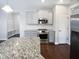 Well-lit kitchen featuring stainless steel appliances, granite countertops, and ample storage space at 69 Azul Dr, Clayton, NC 27520