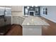 Bright kitchen featuring stainless steel appliances and a spacious island with a granite countertop at 69 Azul Dr, Clayton, NC 27520