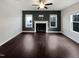 Spacious living room featuring a fireplace, dark wood floors, and natural light at 69 Azul Dr, Clayton, NC 27520