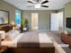 Bedroom with a ceiling fan, carpet floors, and access to the ensuite bathroom and closet at 69 Azul Dr, Clayton, NC 27520