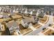 Real estate aerial view of a residential neighborhood, showing street view and backyard setups at 717 Tailrace Falls Ct, Wake Forest, NC 27587