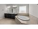 Spacious bathroom with double vanity, soaking tub, and natural light at 717 Tailrace Falls Ct, Wake Forest, NC 27587