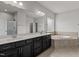 Bright bathroom featuring a double sink vanity and a soaking tub at 717 Tailrace Falls Ct, Wake Forest, NC 27587