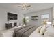 Well-decorated bedroom with a large bed, dresser, modern ceiling fan, and stylish decor at 717 Tailrace Falls Ct, Wake Forest, NC 27587