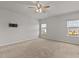 Spacious carpeted bedroom with multiple windows and a ceiling fan at 717 Tailrace Falls Ct, Wake Forest, NC 27587
