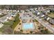 An aerial view highlights the community pool, parking area, and playground amenities for residents at 717 Tailrace Falls Ct, Wake Forest, NC 27587