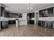 Spacious kitchen featuring dark cabinetry, stainless steel appliances, and a kitchen island at 717 Tailrace Falls Ct, Wake Forest, NC 27587