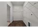 Convenient laundry area with dark wood-look floors and ample shelving at 717 Tailrace Falls Ct, Wake Forest, NC 27587