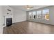 Bright living room with fireplace, ceiling fan, and large windows at 717 Tailrace Falls Ct, Wake Forest, NC 27587