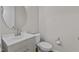 Simple powder room featuring a toilet and vanity with a round mirror at 717 Tailrace Falls Ct, Wake Forest, NC 27587